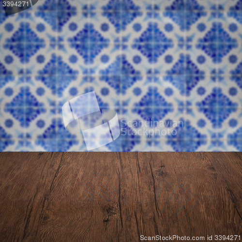 Image of Wood table top and blur vintage ceramic tile pattern wall