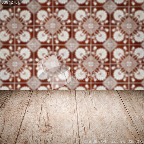 Image of Wood table top and blur vintage ceramic tile pattern wall