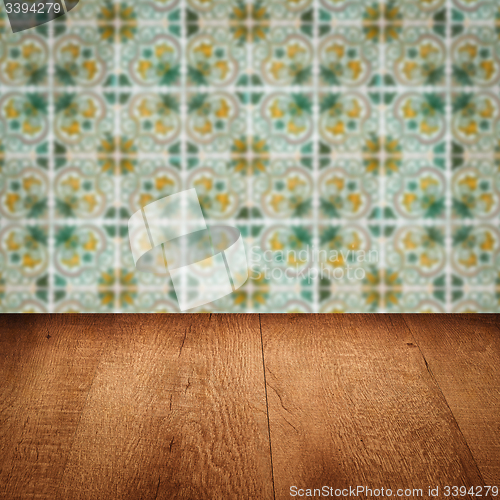 Image of Wood table top and blur vintage ceramic tile pattern wall