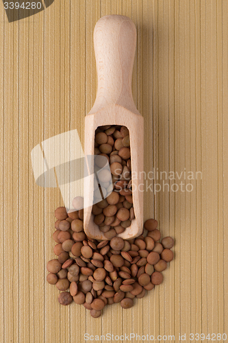 Image of Wooden scoop with lentils