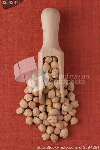 Image of Wooden scoop with chickpeas