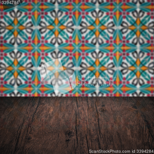 Image of Wood table top and blur vintage ceramic tile pattern wall