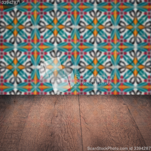 Image of Wood table top and blur vintage ceramic tile pattern wall
