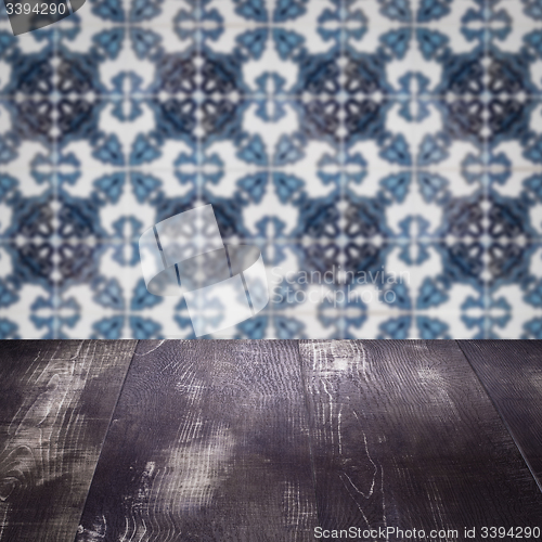 Image of Wood table top and blur vintage ceramic tile pattern wall