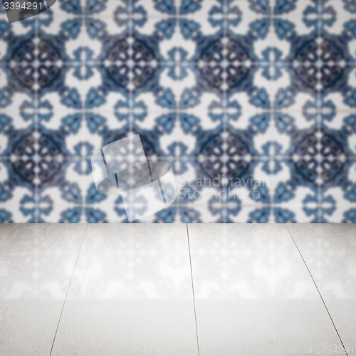 Image of Wood table top and blur vintage ceramic tile pattern wall