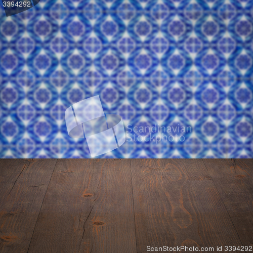 Image of Wood table top and blur vintage ceramic tile pattern wall