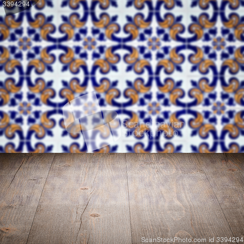 Image of Wood table top and blur vintage ceramic tile pattern wall