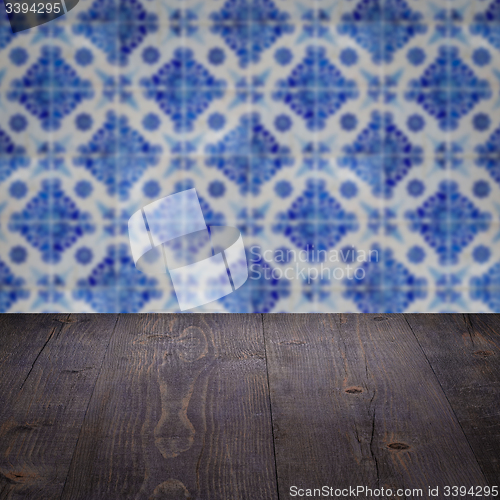 Image of Wood table top and blur vintage ceramic tile pattern wall