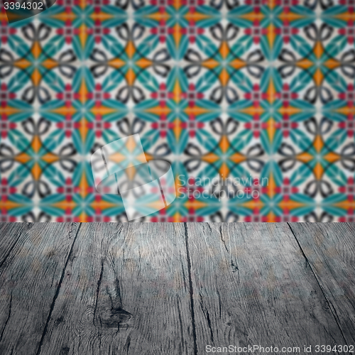 Image of Wood table top and blur vintage ceramic tile pattern wall
