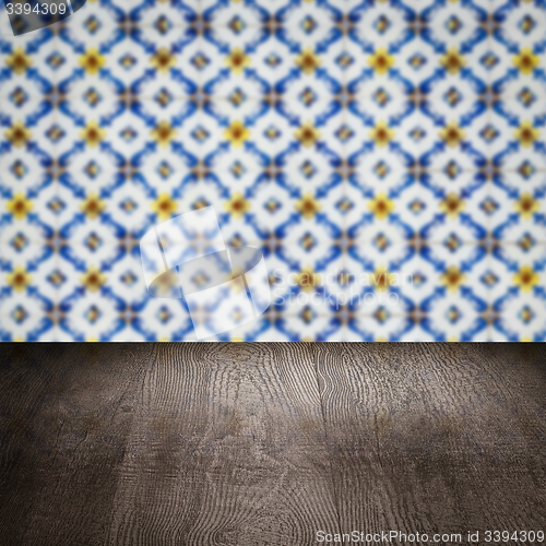 Image of Wood table top and blur vintage ceramic tile pattern wall