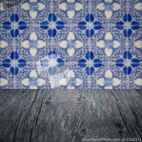 Image of Wood table top and blur vintage ceramic tile pattern wall