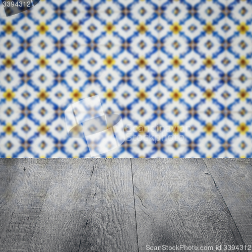 Image of Wood table top and blur vintage ceramic tile pattern wall