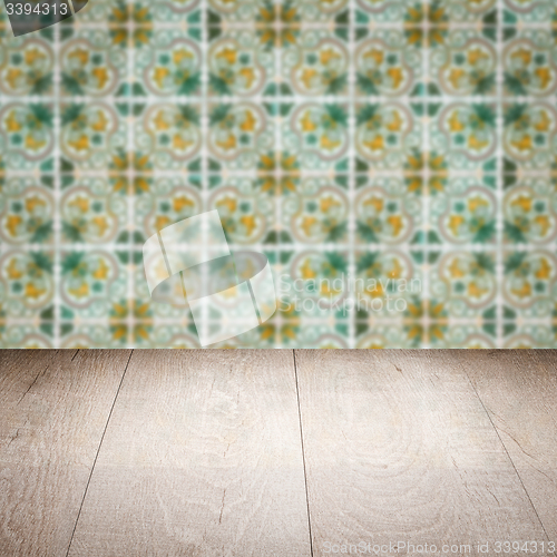 Image of Wood table top and blur vintage ceramic tile pattern wall