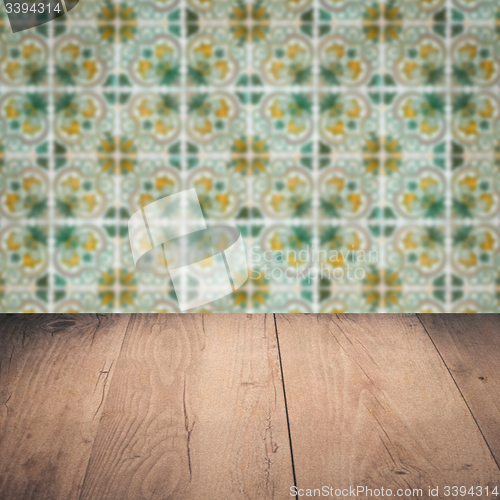 Image of Wood table top and blur vintage ceramic tile pattern wall