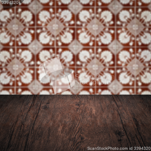Image of Wood table top and blur vintage ceramic tile pattern wall