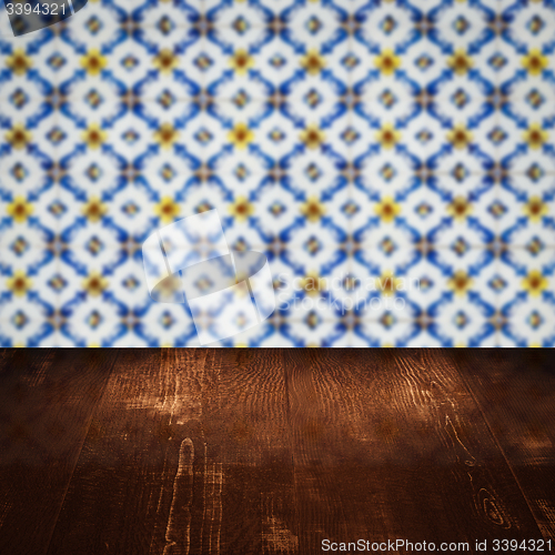 Image of Wood table top and blur vintage ceramic tile pattern wall