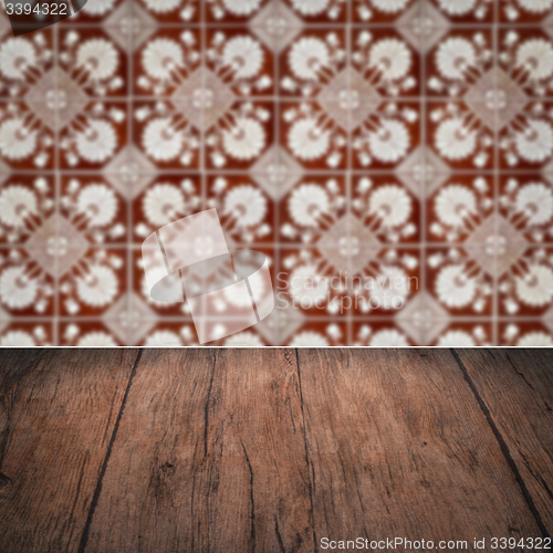 Image of Wood table top and blur vintage ceramic tile pattern wall
