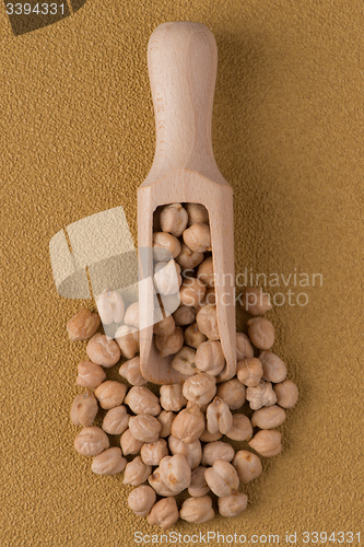 Image of Wooden scoop with chickpeas