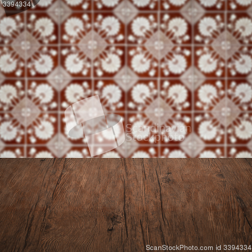 Image of Wood table top and blur vintage ceramic tile pattern wall