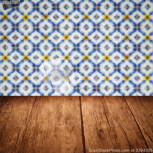 Image of Wood table top and blur vintage ceramic tile pattern wall