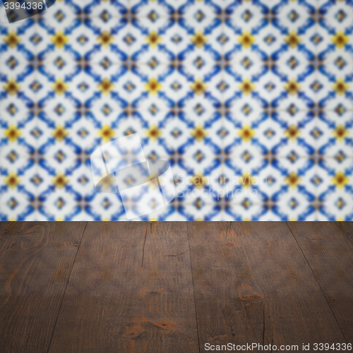 Image of Wood table top and blur vintage ceramic tile pattern wall