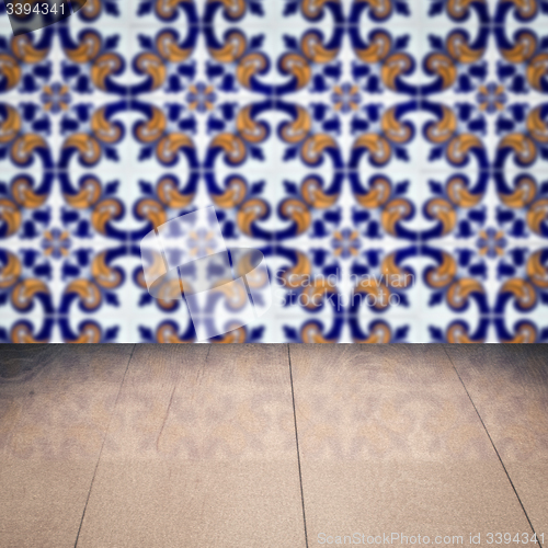 Image of Wood table top and blur vintage ceramic tile pattern wall