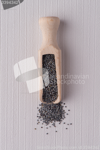 Image of Wooden scoop with poppy seeds