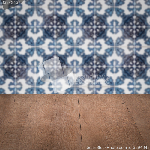 Image of Wood table top and blur vintage ceramic tile pattern wall