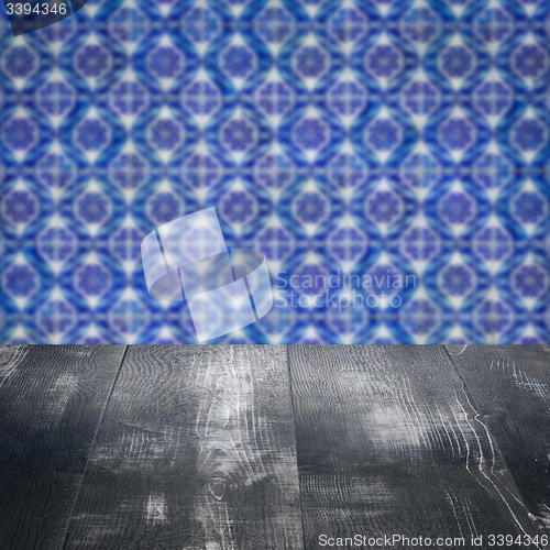 Image of Wood table top and blur vintage ceramic tile pattern wall
