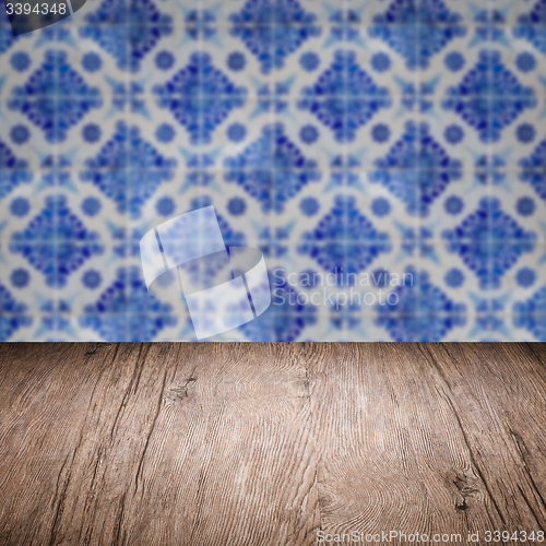 Image of Wood table top and blur vintage ceramic tile pattern wall