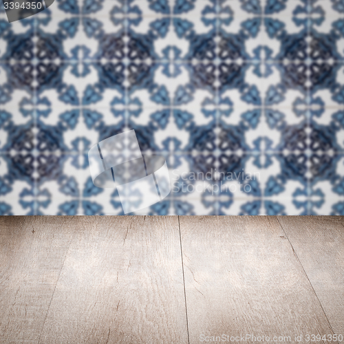 Image of Wood table top and blur vintage ceramic tile pattern wall
