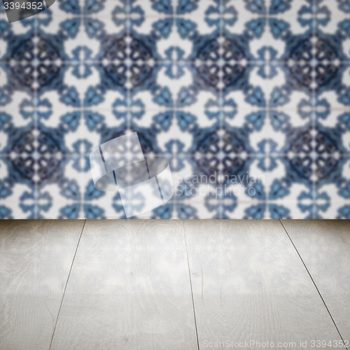 Image of Wood table top and blur vintage ceramic tile pattern wall