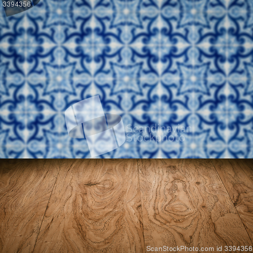 Image of Wood table top and blur vintage ceramic tile pattern wall