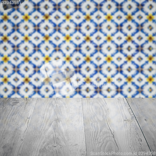Image of Wood table top and blur vintage ceramic tile pattern wall