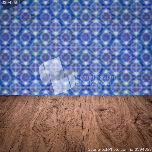 Image of Wood table top and blur vintage ceramic tile pattern wall