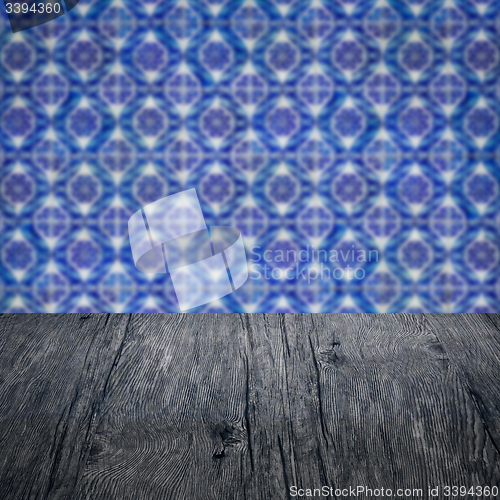 Image of Wood table top and blur vintage ceramic tile pattern wall