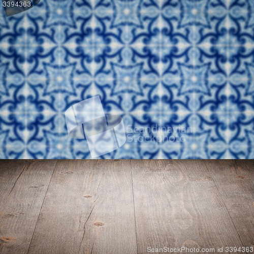 Image of Wood table top and blur vintage ceramic tile pattern wall