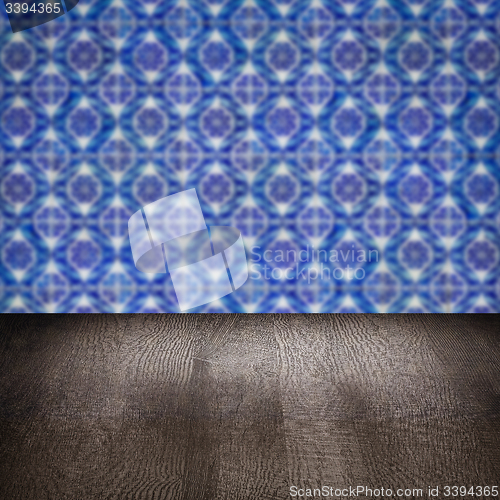 Image of Wood table top and blur vintage ceramic tile pattern wall