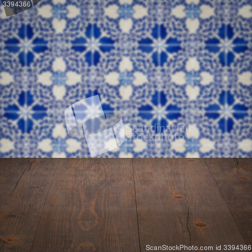 Image of Wood table top and blur vintage ceramic tile pattern wall