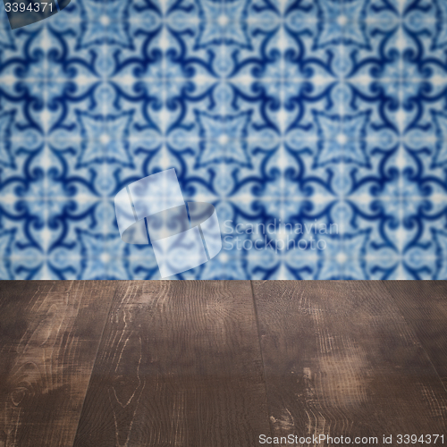 Image of Wood table top and blur vintage ceramic tile pattern wall