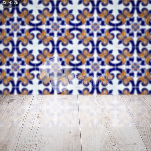 Image of Wood table top and blur vintage ceramic tile pattern wall