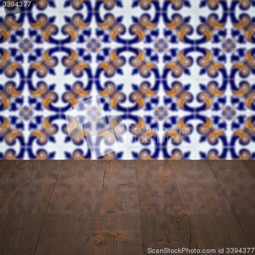 Image of Wood table top and blur vintage ceramic tile pattern wall