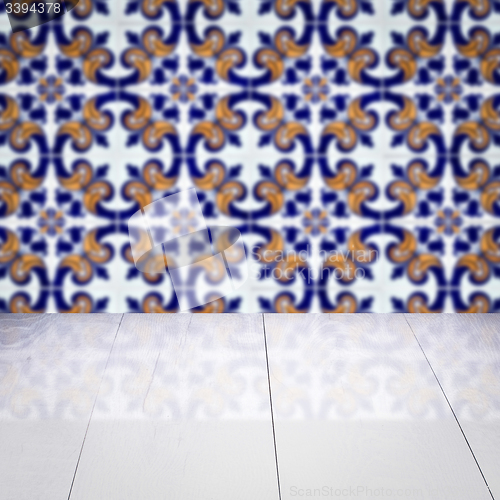 Image of Wood table top and blur vintage ceramic tile pattern wall