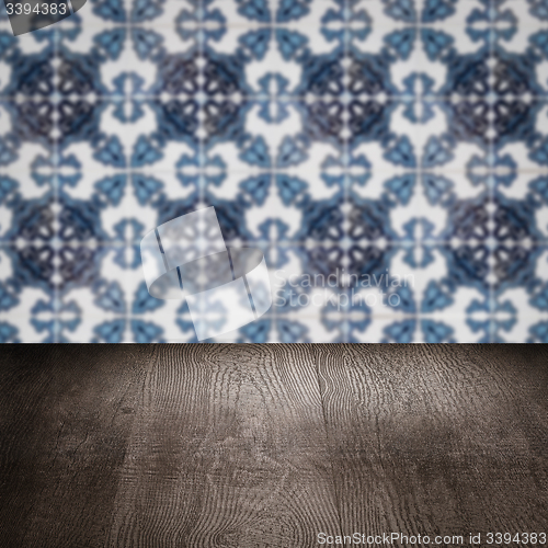 Image of Wood table top and blur vintage ceramic tile pattern wall