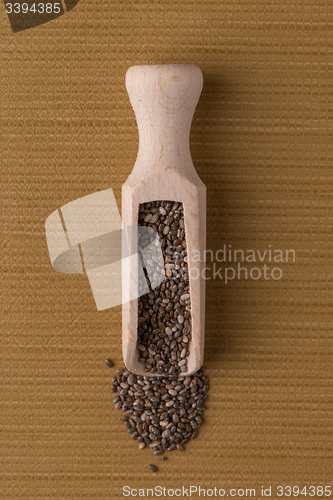 Image of Wooden scoop with chia seeds