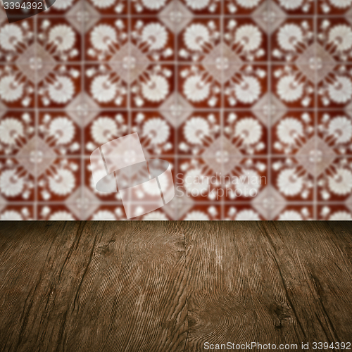 Image of Wood table top and blur vintage ceramic tile pattern wall