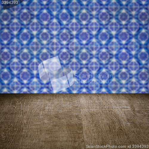 Image of Wood table top and blur vintage ceramic tile pattern wall
