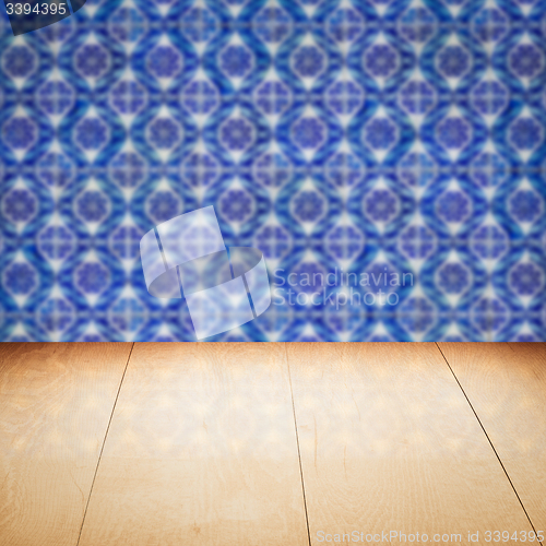 Image of Wood table top and blur vintage ceramic tile pattern wall