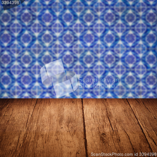 Image of Wood table top and blur vintage ceramic tile pattern wall