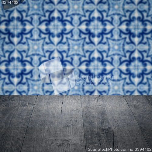 Image of Wood table top and blur vintage ceramic tile pattern wall